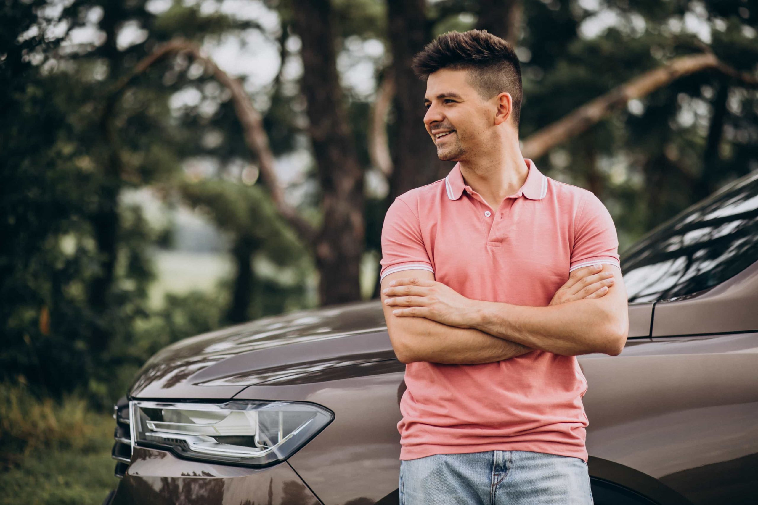 handsome-man-standing-by-his-car-forest